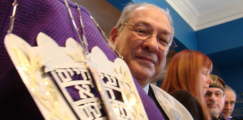 Older gentleman holding the Torah from Beth Israel (Stratford, Ontario)