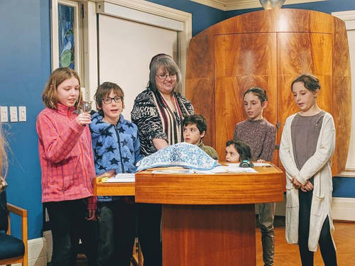 Five young students learning with Rabbi Dressler